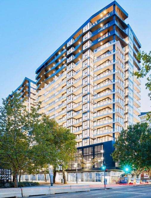 Full view of a high-rise residential tower with extensive exterior glazing