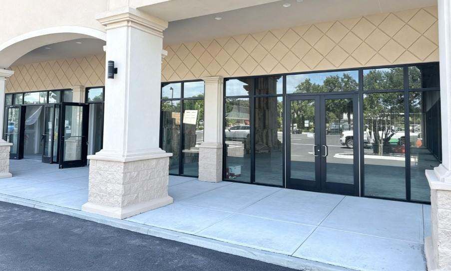 Commercial storefront entrance with black-framed doors and floor-to-ceiling glazing