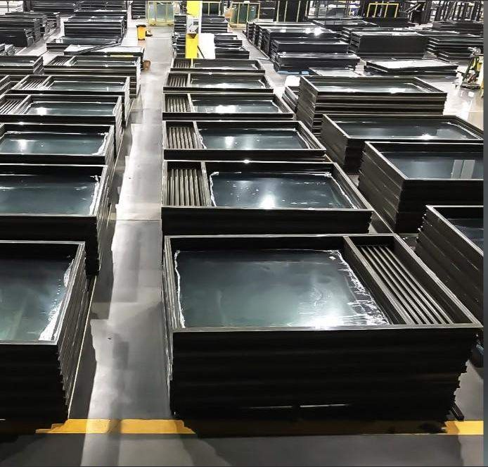 Window frames organized across a factory floor