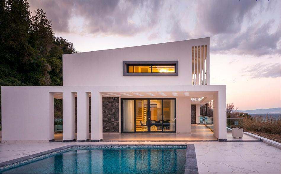 Contemporary white residence with expansive impact glazing overlooking a pool