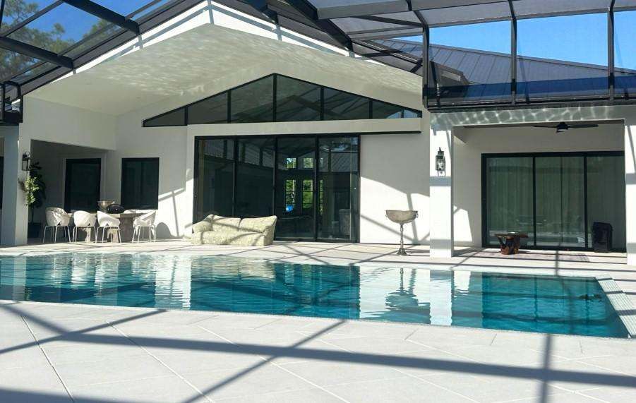 Pool courtyard with impact sliding doors and triangular clerestory glazing