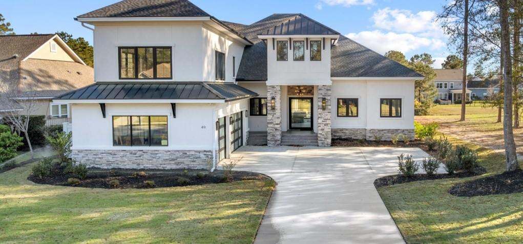 Completed two-story residence with black-framed impact windows